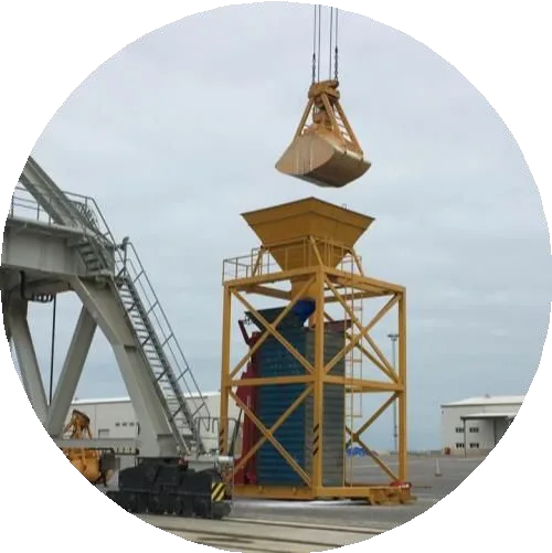 Bulk cargo being loaded into a container through a stuffing hopper at a port